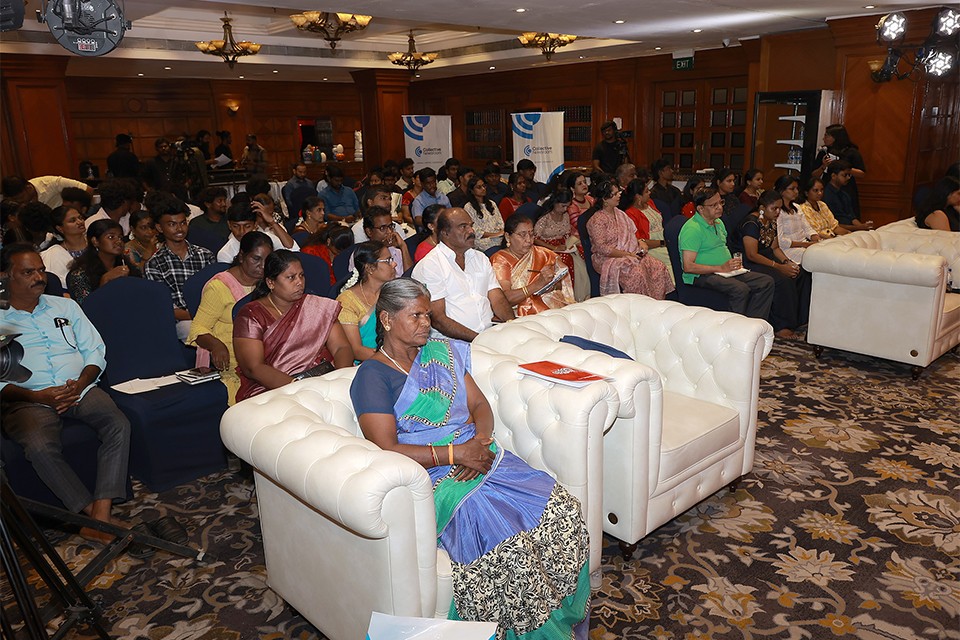 Wide view of audience seated and watching the townhall